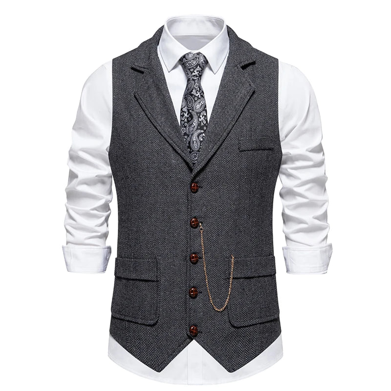 Gray herringbone vest with buttons and a chain on a white shirt with rolled-up sleeves.